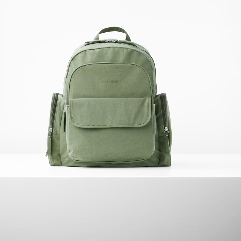 Sage Skip Hop Luna backpack showing the front flap pocket and carry handle