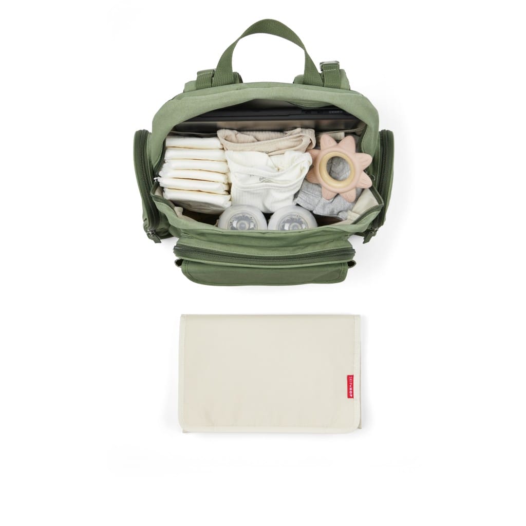 Skip Hop Luna Sage backpack packed with baby essentials beside its changing pad